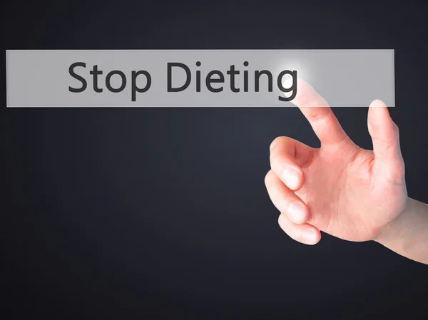 Smettere di dieta - Mano premendo un pulsante su sfondo sfocato conc — Foto Stock