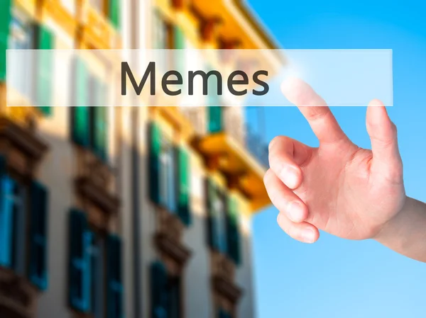 Memes - Hand indrukken van een knop op onscherpe achtergrond concept op — Stockfoto