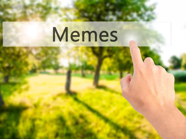 Memes - Hand pressing a button on blurred background concept on — Stock Photo, Image