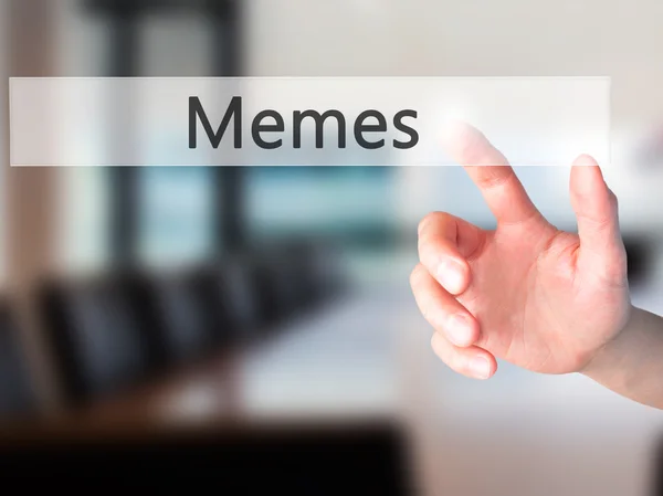 Memes - Hand pressing a button on blurred background concept on — Stock Photo, Image