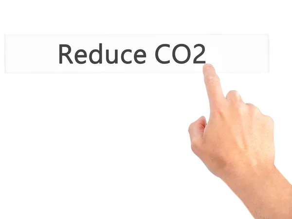 Verminderen van de Co2 - Hand indrukken van een knop op de onscherpe achtergrond concep — Stockfoto