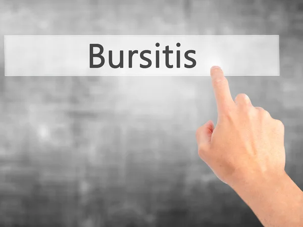 Bursitis - Mano presionando un botón sobre el concepto de fondo borroso — Foto de Stock