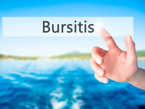 Bursitis - Mano presionando un botón sobre el concepto de fondo borroso — Foto de Stock