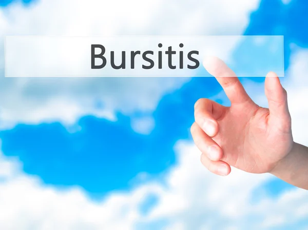 Bursitis - Mano presionando un botón sobre el concepto de fondo borroso — Foto de Stock