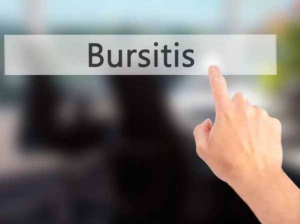 Bursitis - Mano premendo un pulsante sul concetto di sfondo sfocato — Foto Stock