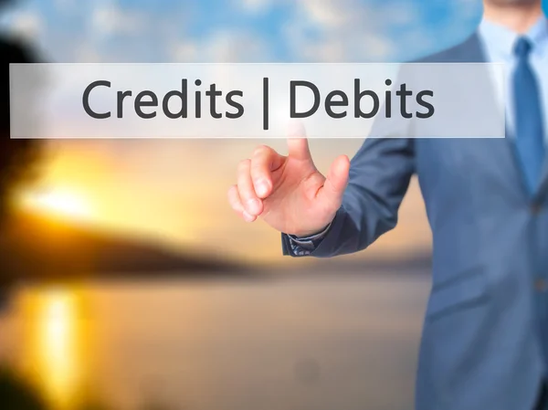 Credits  Debits - Businessman hand pressing button on touch scre — Stock Photo, Image