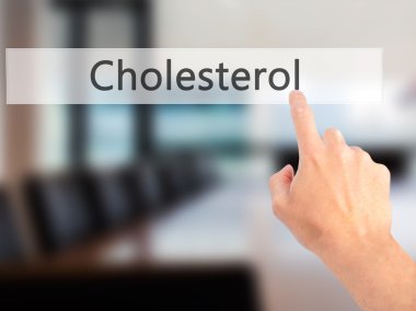Kolesterol - arka plan bulanık conce üzerinde bir düğmeye basarak el