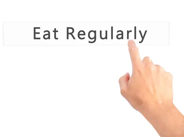 Eat Regularly - Hand pressing a button on blurred background con — Stock Photo, Image