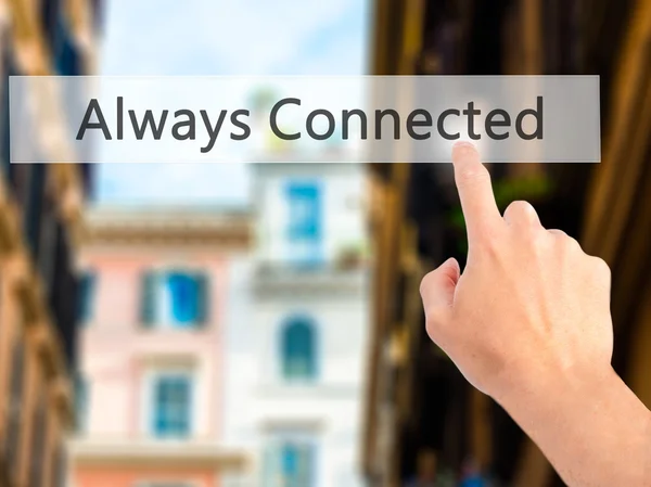 Always Connected - Hand pressing a button on blurred background — Stock Photo, Image