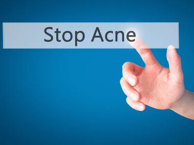 Stop Acne - Hand pressing a button on blurred background concept clipart