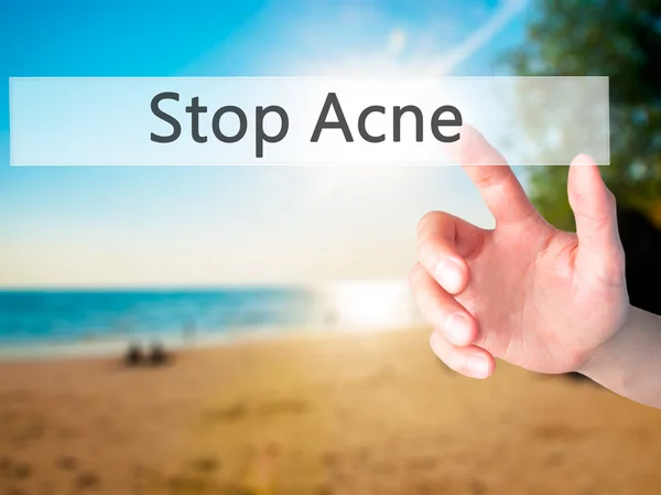 Stop Acne - Hand pressing a button on blurred background concept — Stock Photo, Image