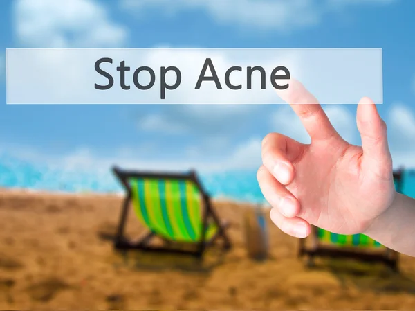 Stop Acne - Hand pressing a button on blurred background concept — Stock Photo, Image