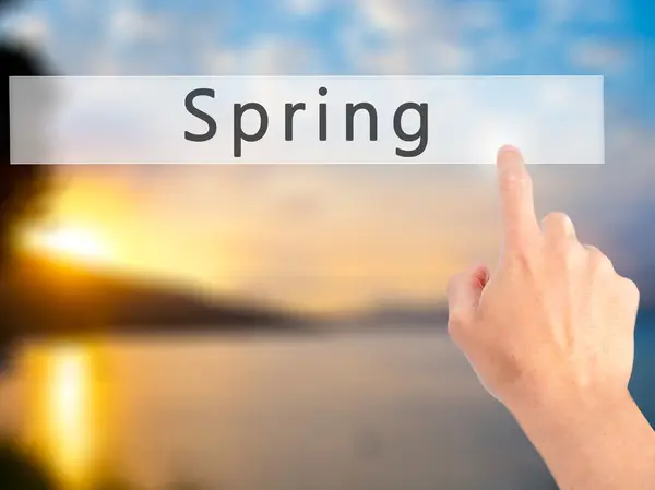 Spring - Hand pressing a button on blurred background concept on — Stock Photo, Image