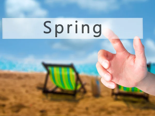 Spring - Hand pressing a button on blurred background concept on — Stock Photo, Image