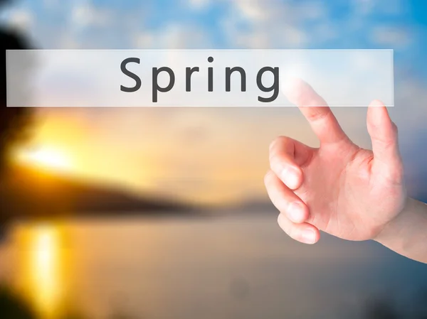 Spring - Hand pressing a button on blurred background concept on — Stock Photo, Image