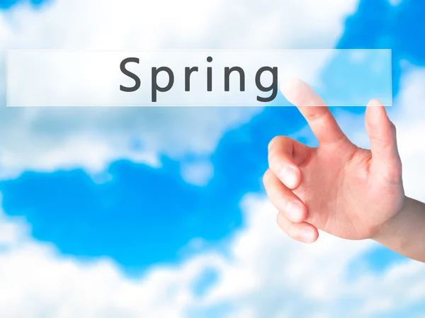 Spring - Hand pressing a button on blurred background concept on — Stock Photo, Image