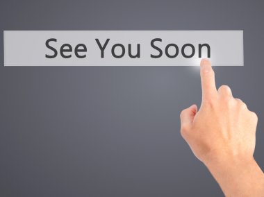 See You Soon - Hand pressing a button on blurred background conc clipart