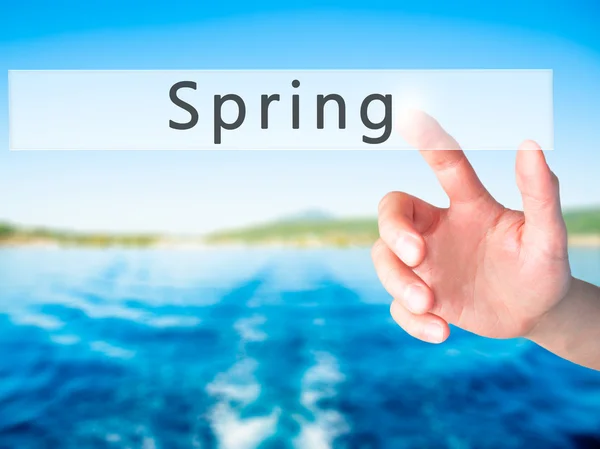 Spring - Hand pressing a button on blurred background concept on — Stock Photo, Image