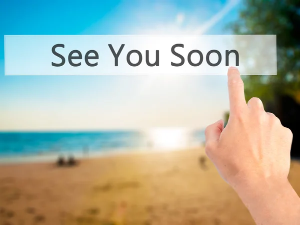 See You Soon - Hand pressing a button on blurred background conc — Stock Photo, Image