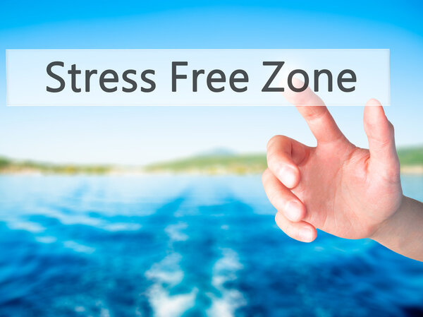 Stress Free Zone - Hand pressing a button on blurred background 