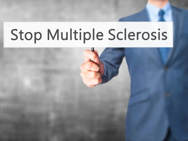 Stop Multiple Sclerosis - Businessman hand holding sign — Stock Photo, Image