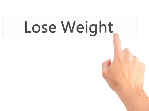 Gewicht verlieren - Hand auf Knopfdruck auf verschwommenem Hintergrund — Stockfoto