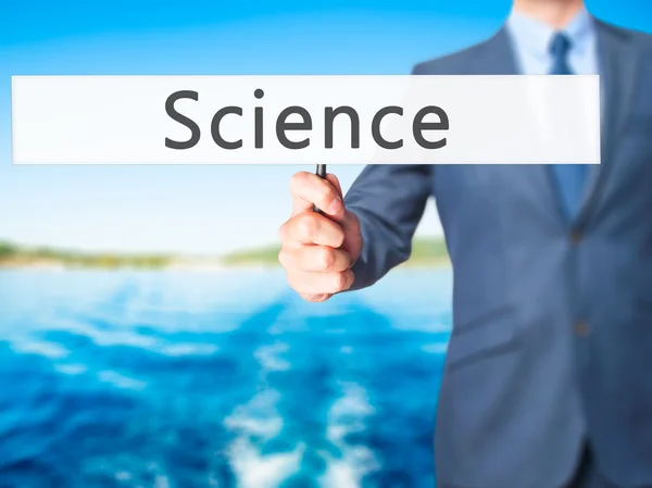 Science-affärsman hand innehav Sign — Stockfoto