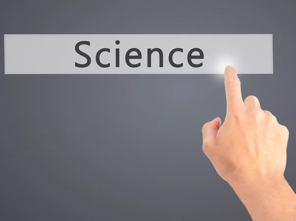 Επιστήμη - χέρι πιέζοντας ένα κουμπί στο o έννοια θολή φόντο — Φωτογραφία Αρχείου