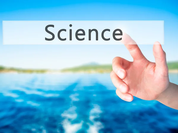 Science - Hand pressing a button on blurred background concept o — Stock Photo, Image