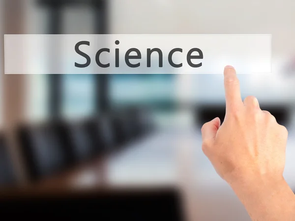 Science - Hand pressing a button on blurred background concept o — Stock Photo, Image