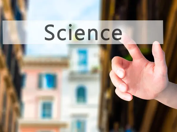 Science - Hand pressing a button on blurred background concept o — Stock Photo, Image