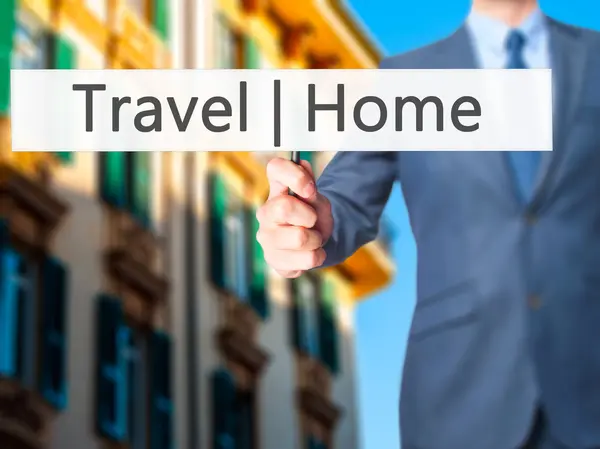 Travel  Home - Businessman hand holding sign — Stock Photo, Image