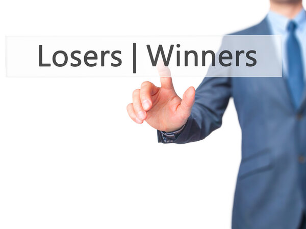 Winners  Losers - Businessman hand pressing button on touch scre