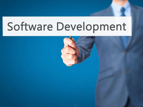 Desarrollo de software - Empresario mano sosteniendo el cartel — Foto de Stock