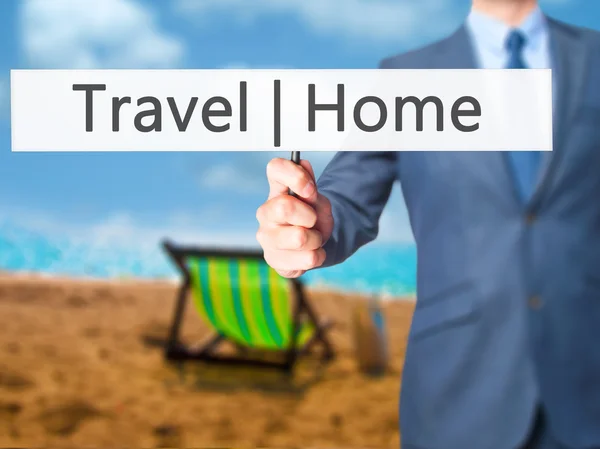 Travel  Home - Businessman hand holding sign — Stock Photo, Image