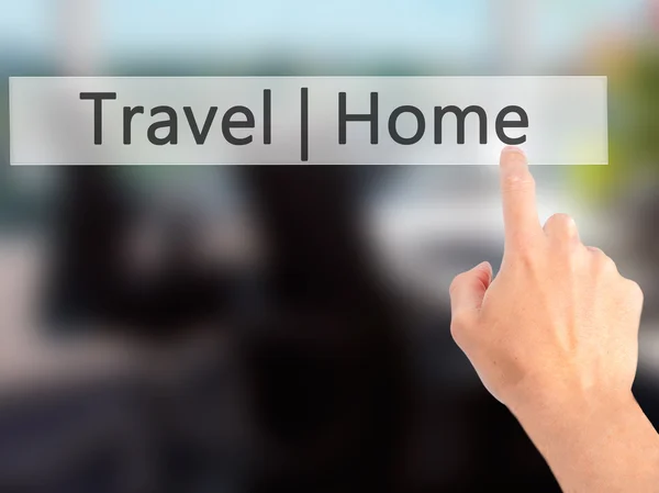 Travel Home - Mano premendo un pulsante su sfondo sfocato conc — Foto Stock
