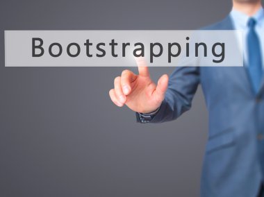 Bootstrapping - Businessman hand pressing button on touch screen clipart