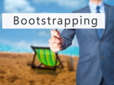 Bootstrapping - Businessman hand holding sign clipart