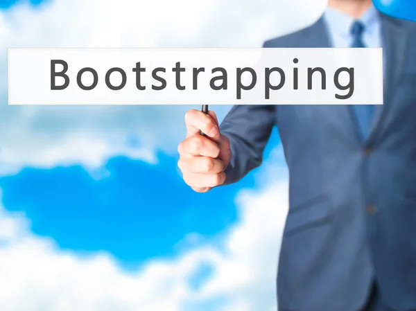 Bootstrap - biznesmen ręka trzyma znak — Zdjęcie stockowe
