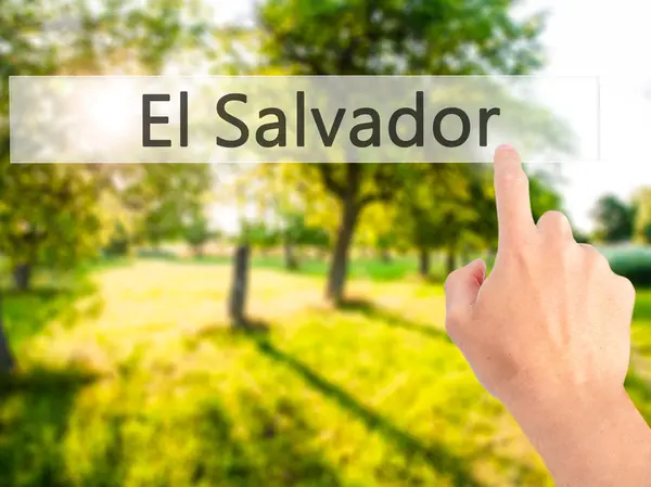 El Salvador - Mano premendo un pulsante su sfondo sfocato conce — Foto Stock