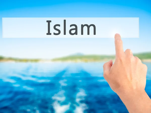 Islam - ręcznie naciskając przycisk na pojęcie nieostre tło — Zdjęcie stockowe