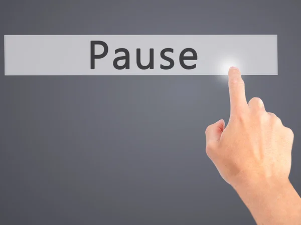 Pause - Hand pressing a button on blurred background concept on — Stock Photo, Image