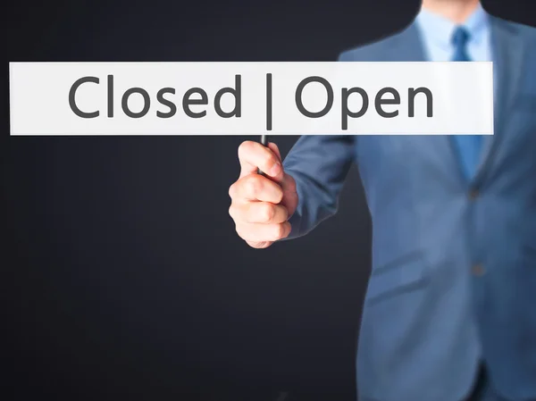 Open Closed - Businessman hand holding sign — Stock Photo, Image