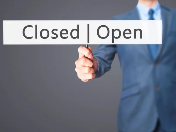 Open Closed - Businessman hand holding sign — Stock Photo, Image