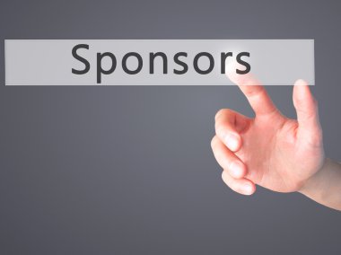 Sponsorlar - arka plan bulanık kavramı üzerinde bir düğmeye basarak el 