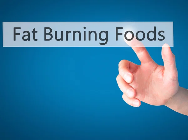 Fat Burning Foods - Hand pressing a button on blurred background — Stock Photo, Image