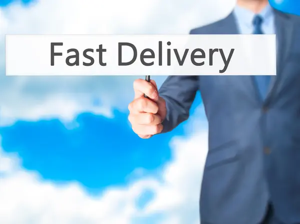 Fast Delivery - Businessman hand holding sign — Stock Photo, Image