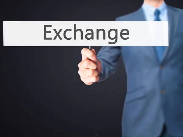 Exchange - zakenman hand hebt van teken — Stockfoto