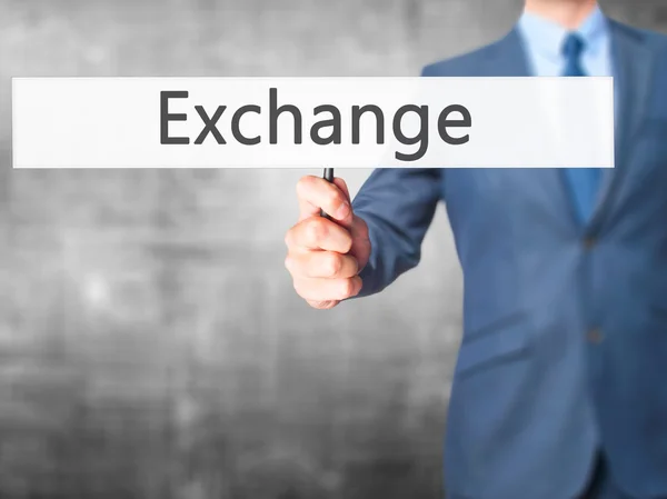 Exchange - zakenman hand hebt van teken — Stockfoto