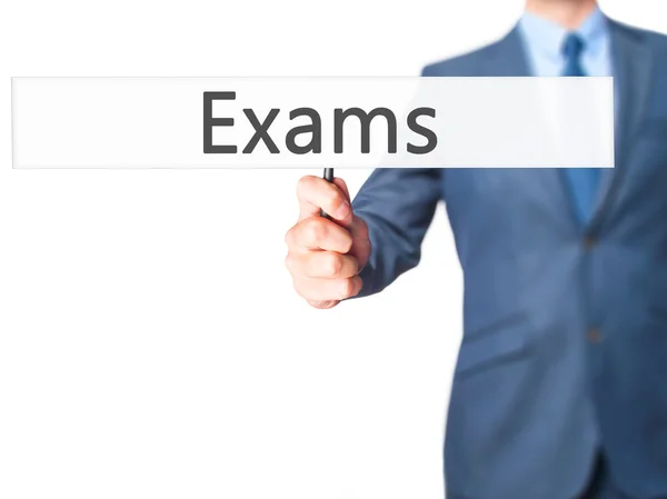 Exams - Businessman hand holding sign — Stock Photo, Image